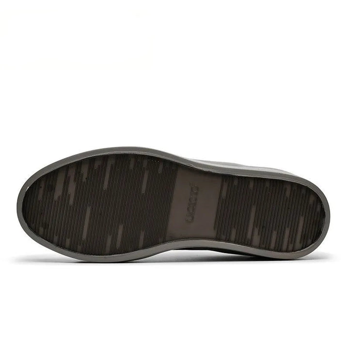 The bottom sole of a U-CCO Leisure Brand shoe, showing a dark brown textured tread pattern and a gray outer edge, presented on a white background with the brand logo in the top left corner.