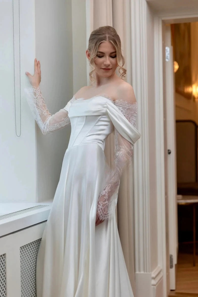 Ivory off-shoulder satin bridal gown with sheer lace long sleeves and A-line silhouette