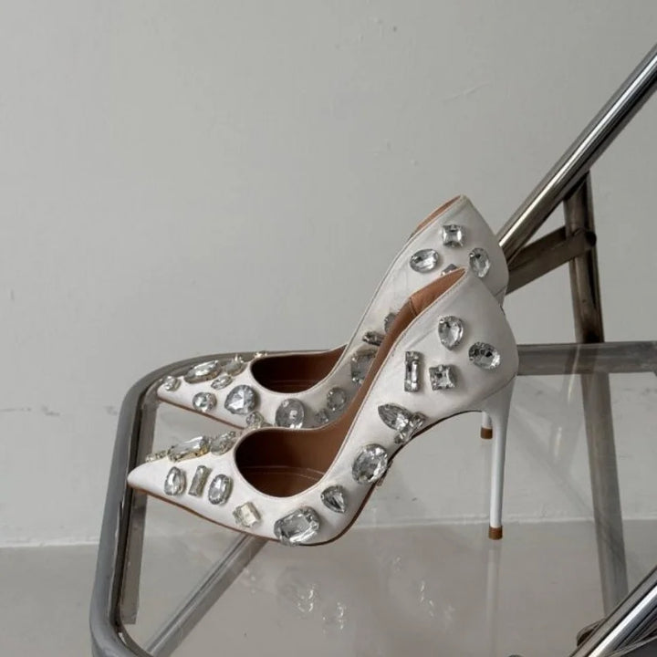 White satin crystal heel pumps with silver-toned gem embellishments and pointed toe
