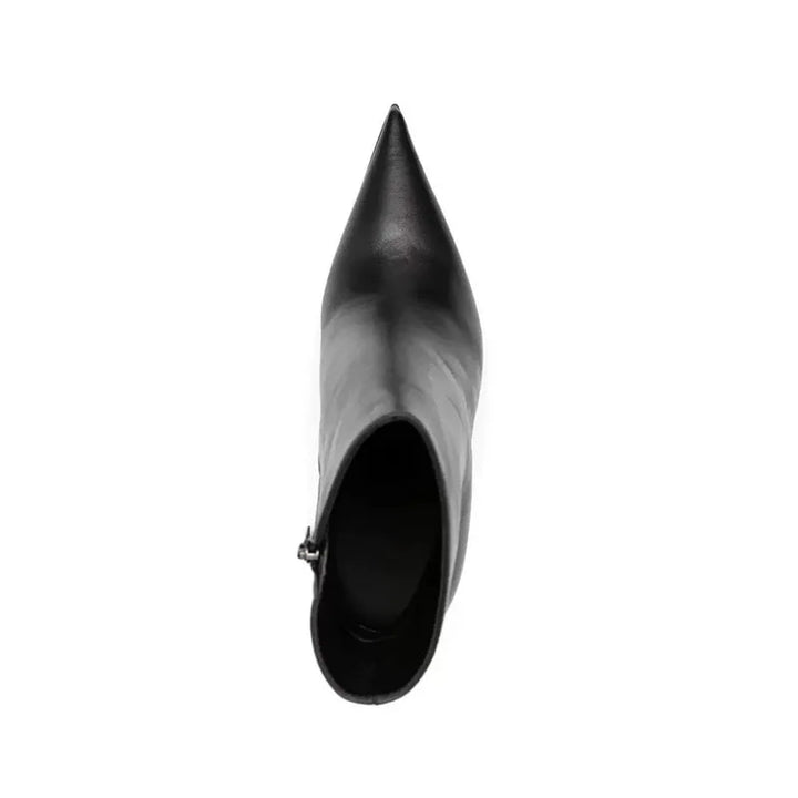 Black pointed-toe ankle boot showing open interior and sock lining