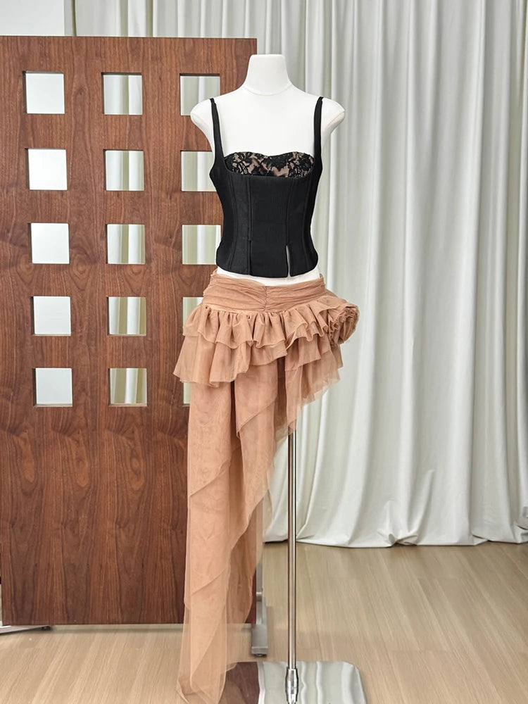 Black corset top with lace overlay and peach asymmetrical layered tulle maxi skirt