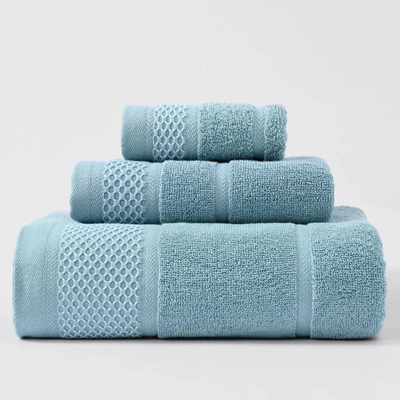 3-piece thick cotton towel set in light blue, folded and rolled with waffle pattern.