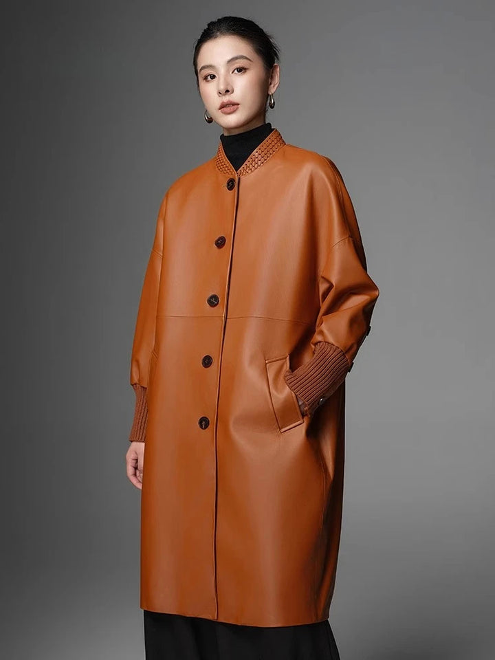 Women’s orange woven coat with stand collar, button front, patch pockets, and ribbed cuffs