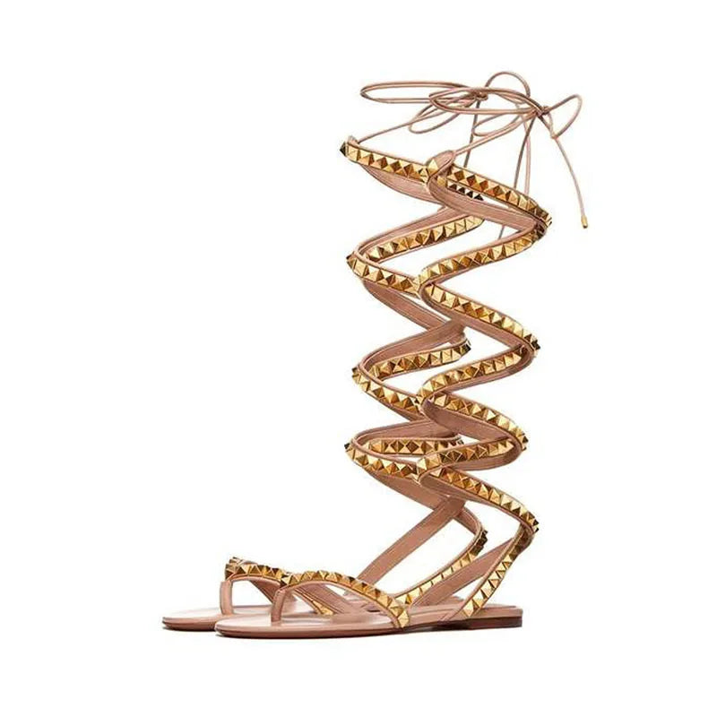 Apricot beige flat sandals with gold zigzag stud trim and long wrap ankle laces