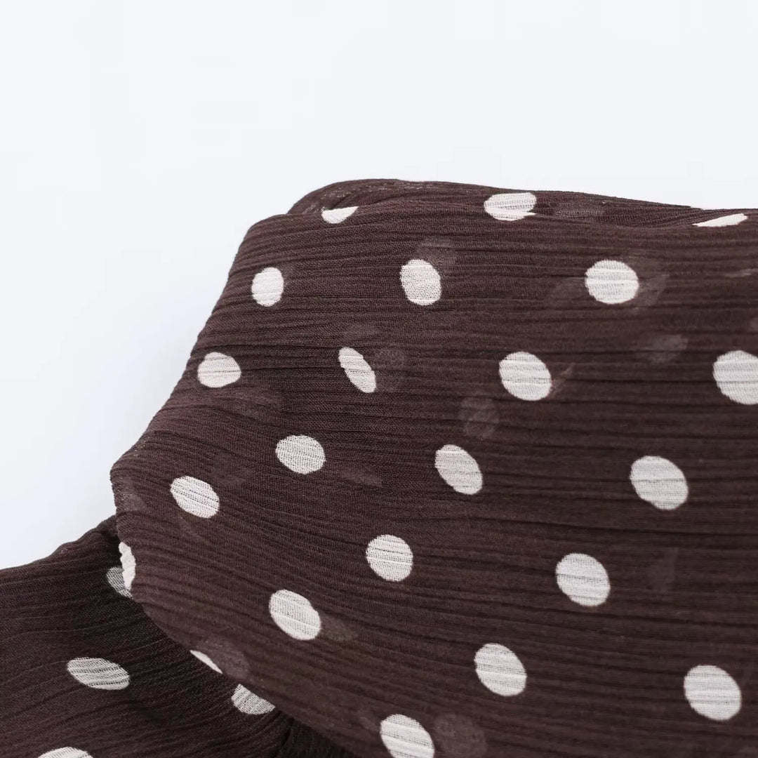 Women’s chiffon high-neck blouse fabric close-up, dark brown with white polka dots