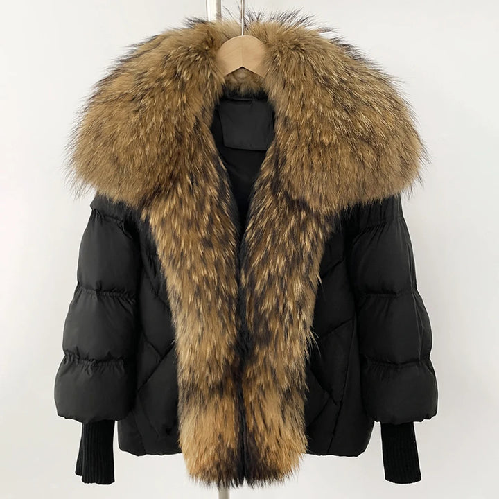 Black puffer coat with long tan faux-fur hood trim and ribbed knit cuffs
