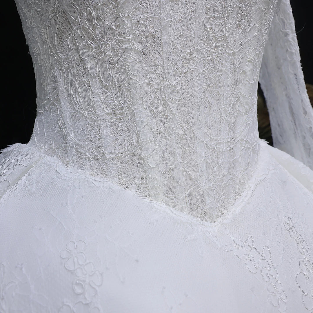 White lace high-neck wedding gown bodice detail with floral lace texture