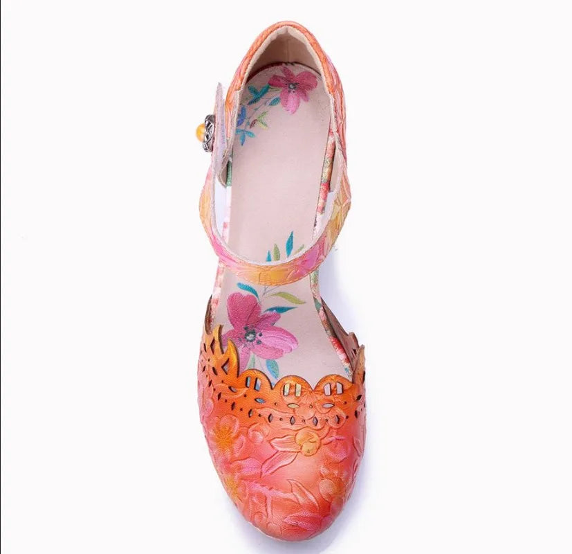 Leather sandal showing interior footbed, orange/pink floral upper and ankle strap