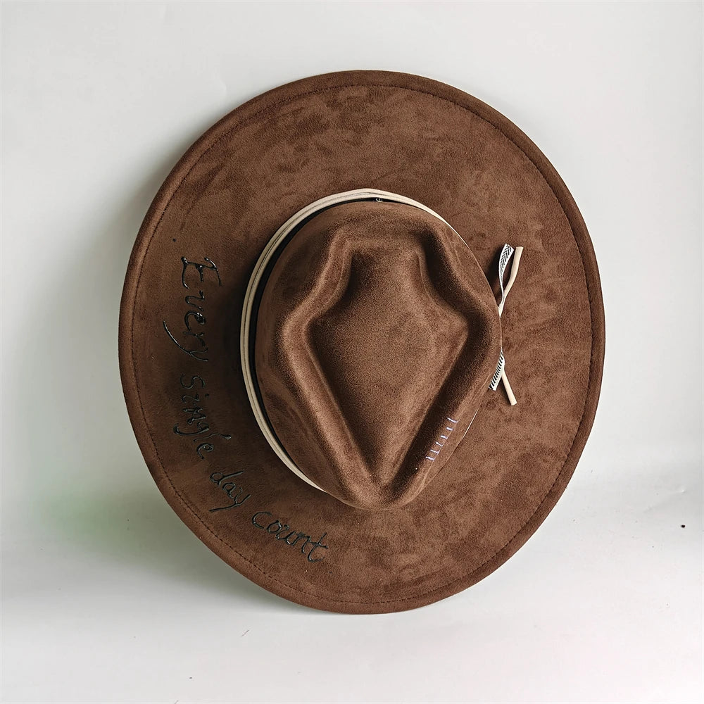 Chocolate brown suede arrow top hat with white braided hatband and side bow detail