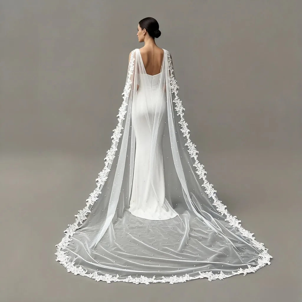 Sheer white bridal cape with pearl lace edge and long train