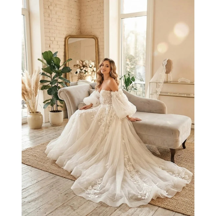 Ivory off-shoulder bridal gown with 3D floral lace bodice and flowing tulle skirt