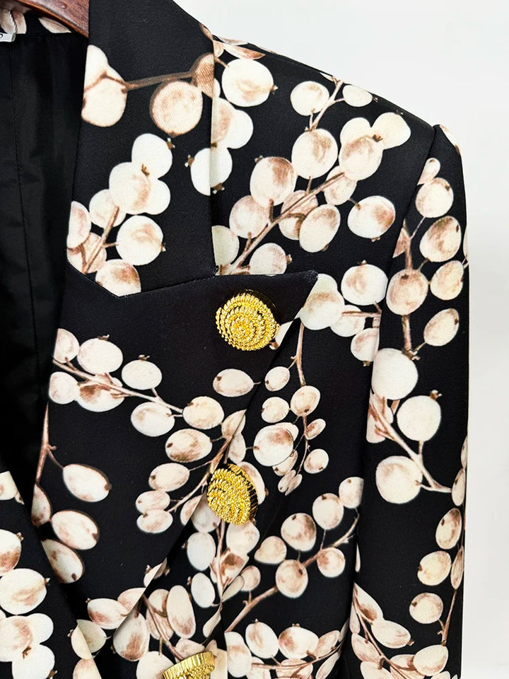 Black blazer jacket lapel with gold round clasp and cream oval chain pattern
