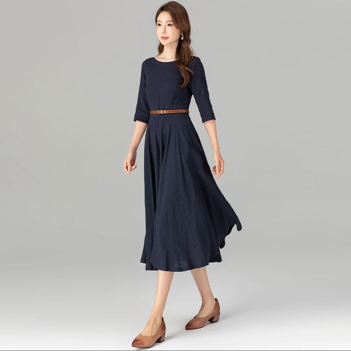 Dark blue midi dress with 3/4 sleeves, gathered skirt, and waist belt