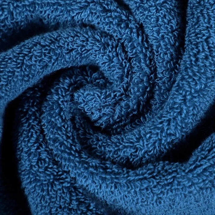 Blue cotton towel embroidery detail with swirling stitched crest