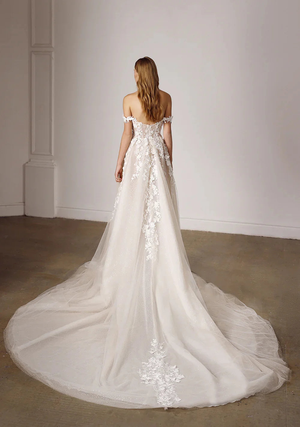 Off-shoulder lace bridal gown, back view with long train