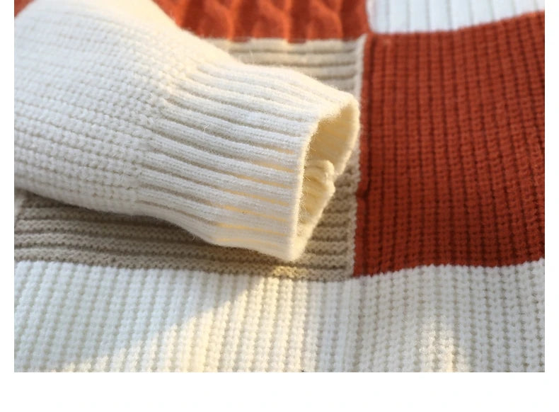 Patchwork knit sweater closeup of ribbed cuff in cream with orange/brown panel knit.