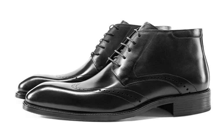 Black lace-up brogue ankle boots with decorative perforations and low stacked heel