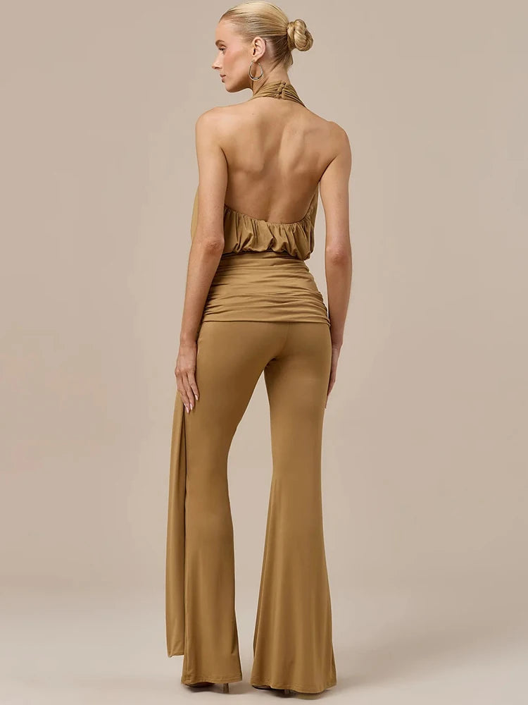 Brown backless halter jumpsuit with ruched back detailing and flowing wide-leg pants
