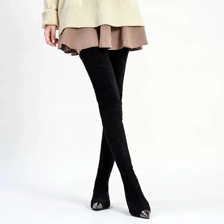 Women’s thigh-high faux suede boots on model, black pointed toe