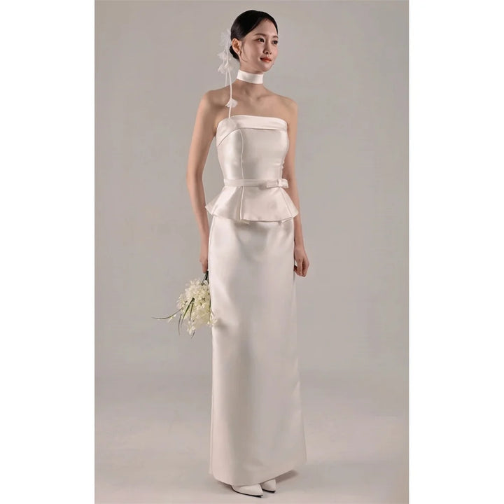 White strapless satin wedding dress with peplum waist and long fitted skirt