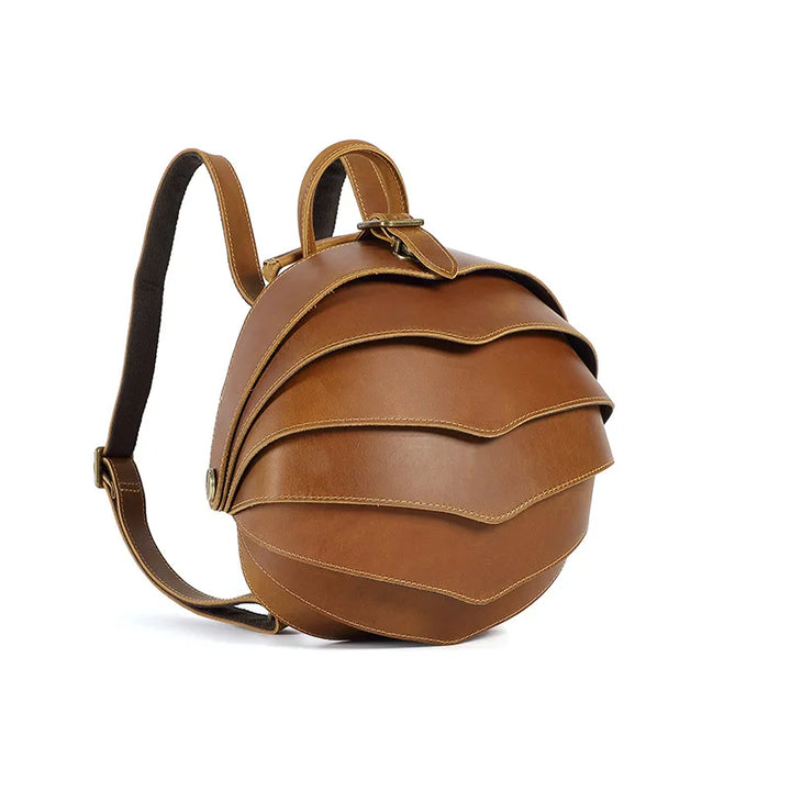 Brown leather backpack with curved flap, front stitching lines, adjustable shoulder strap