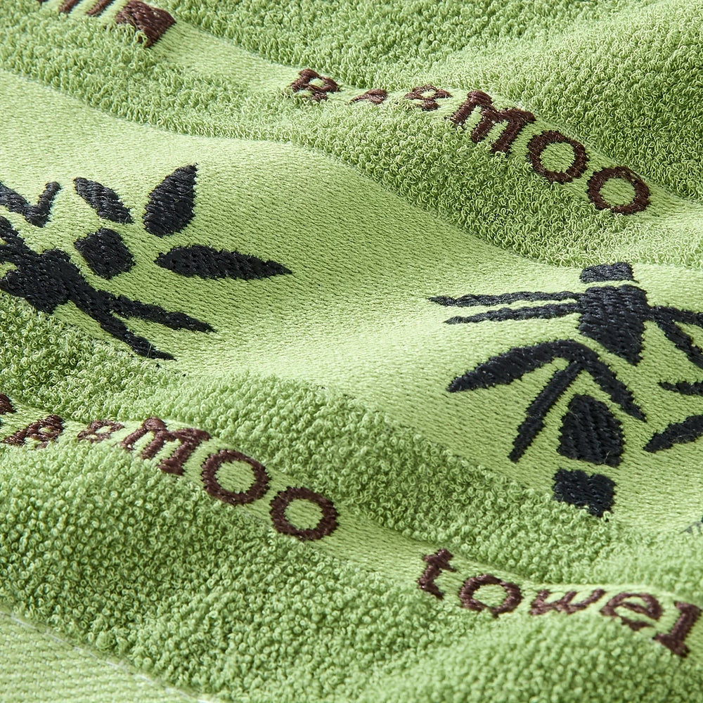 Green terry towel with black leaf pattern and decorative band
