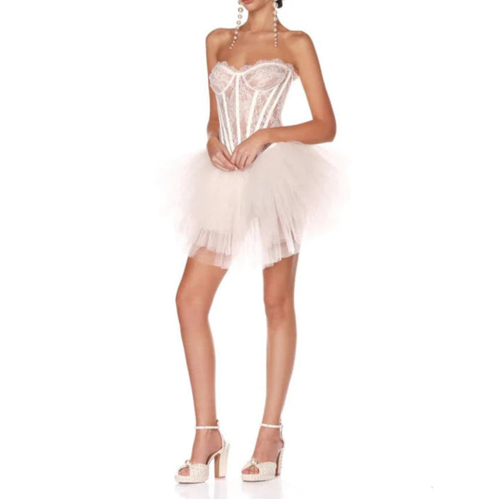 Woman wearing a white sequined dress on a white background