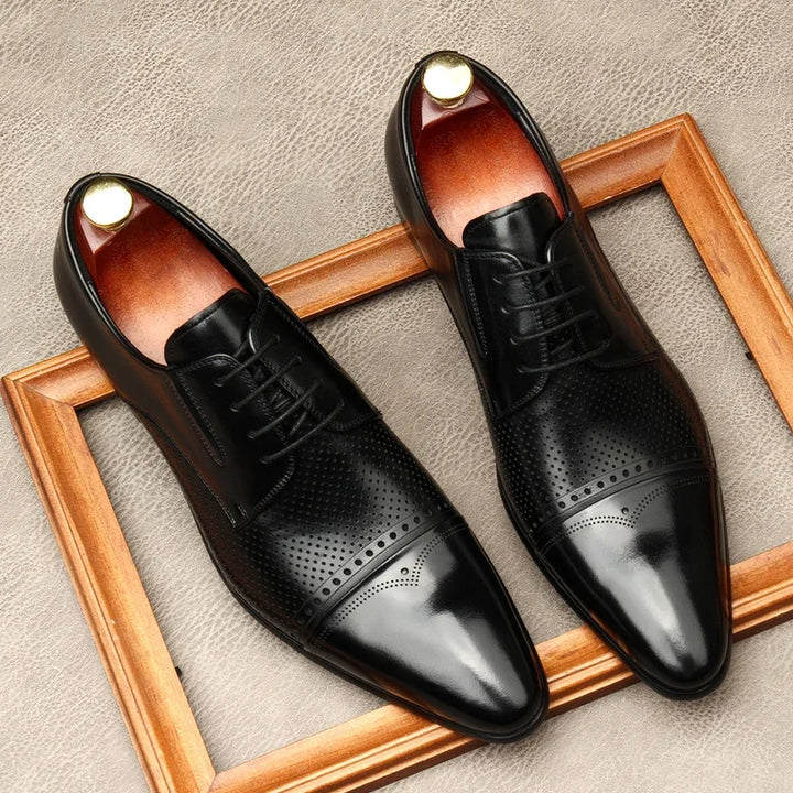 Pair of black lace-up leather shoes with perforated quarters and glossy finish