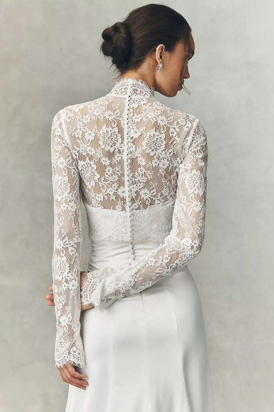 White lace bridal jacket with high neck and long sleeves, back view over fitted waist