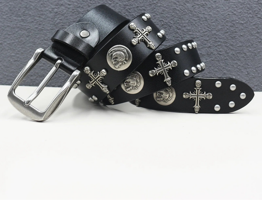 Black leather belt with silver studs and cross designs on a gray background