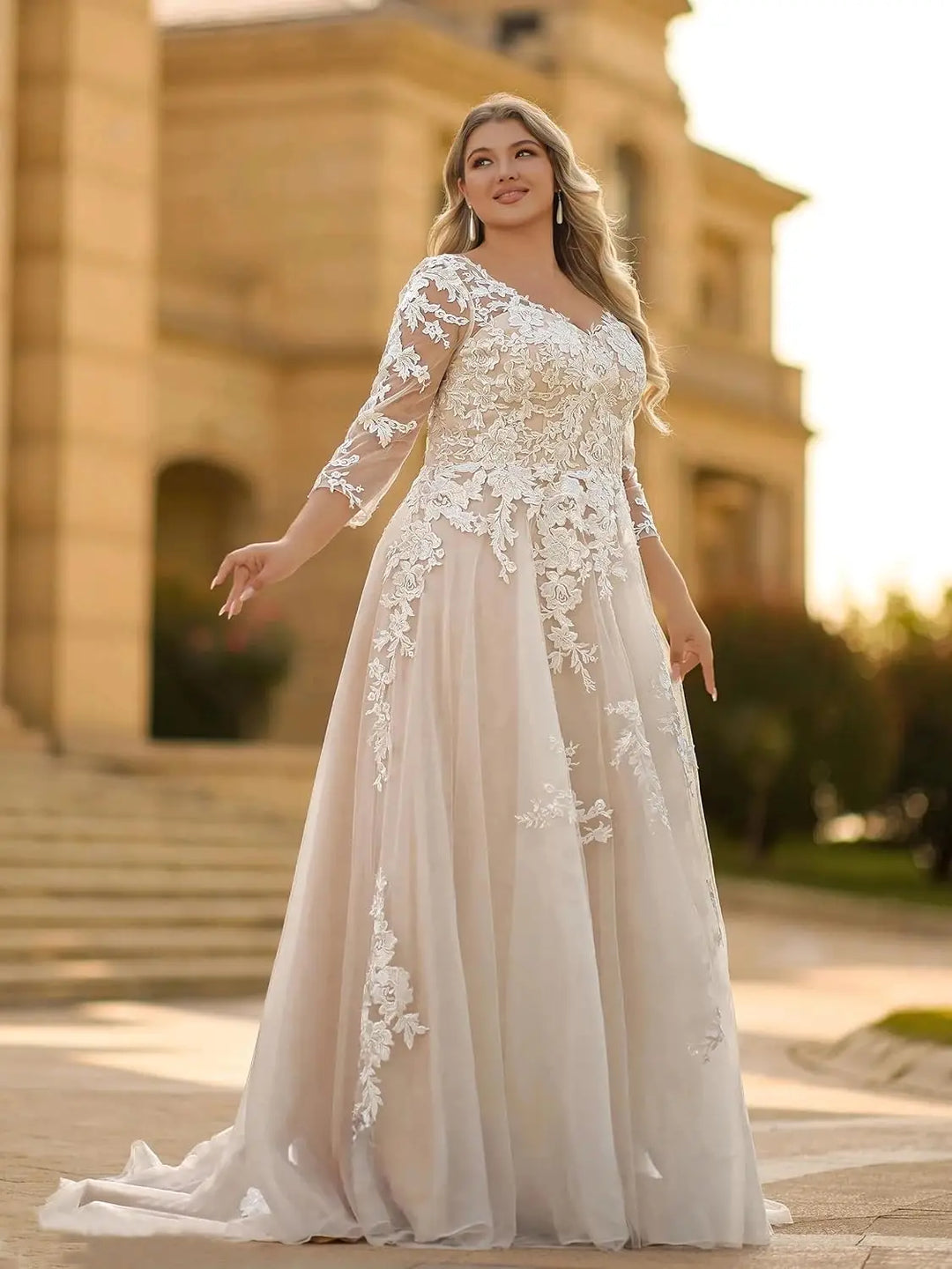 Ivory lace wedding dress with scalloped lace bodice, illusion sleeves, and flowing A-line skirt.