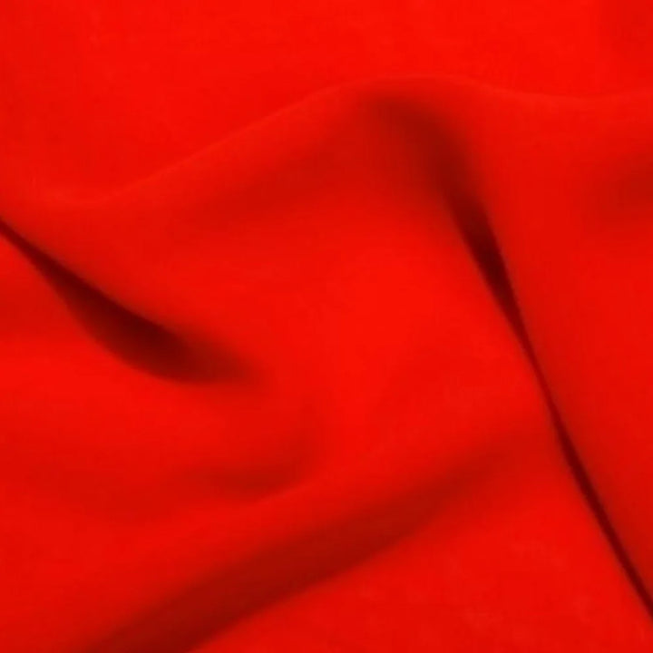 Red satin fabric close-up with smooth folds