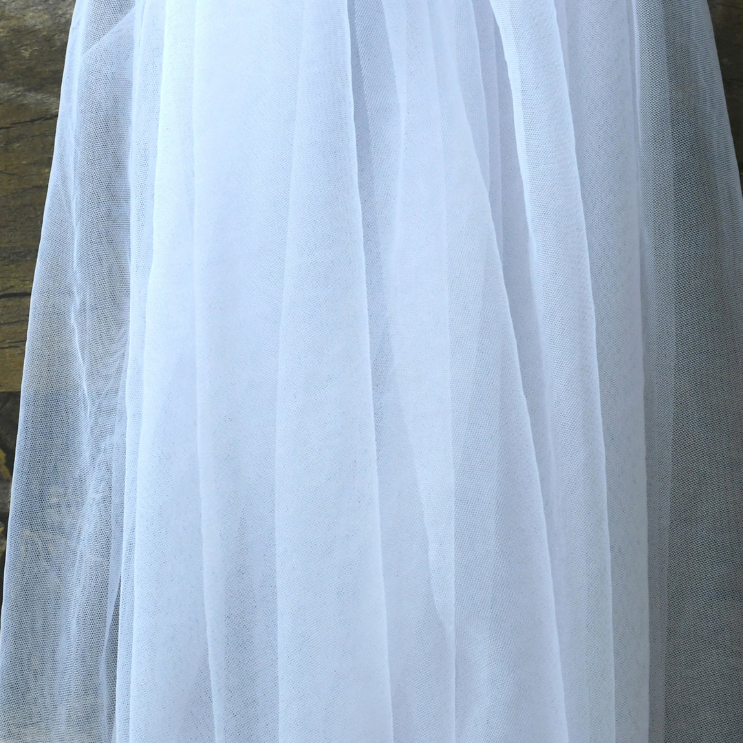 White sheer tulle bridal veil close-up with smooth drape and light texture