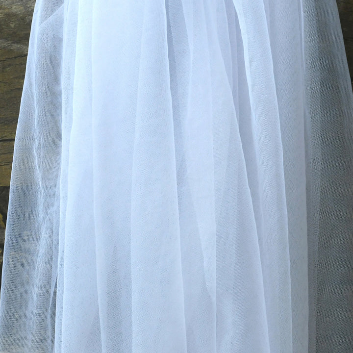 White sheer tulle bridal veil close-up with smooth drape and light texture