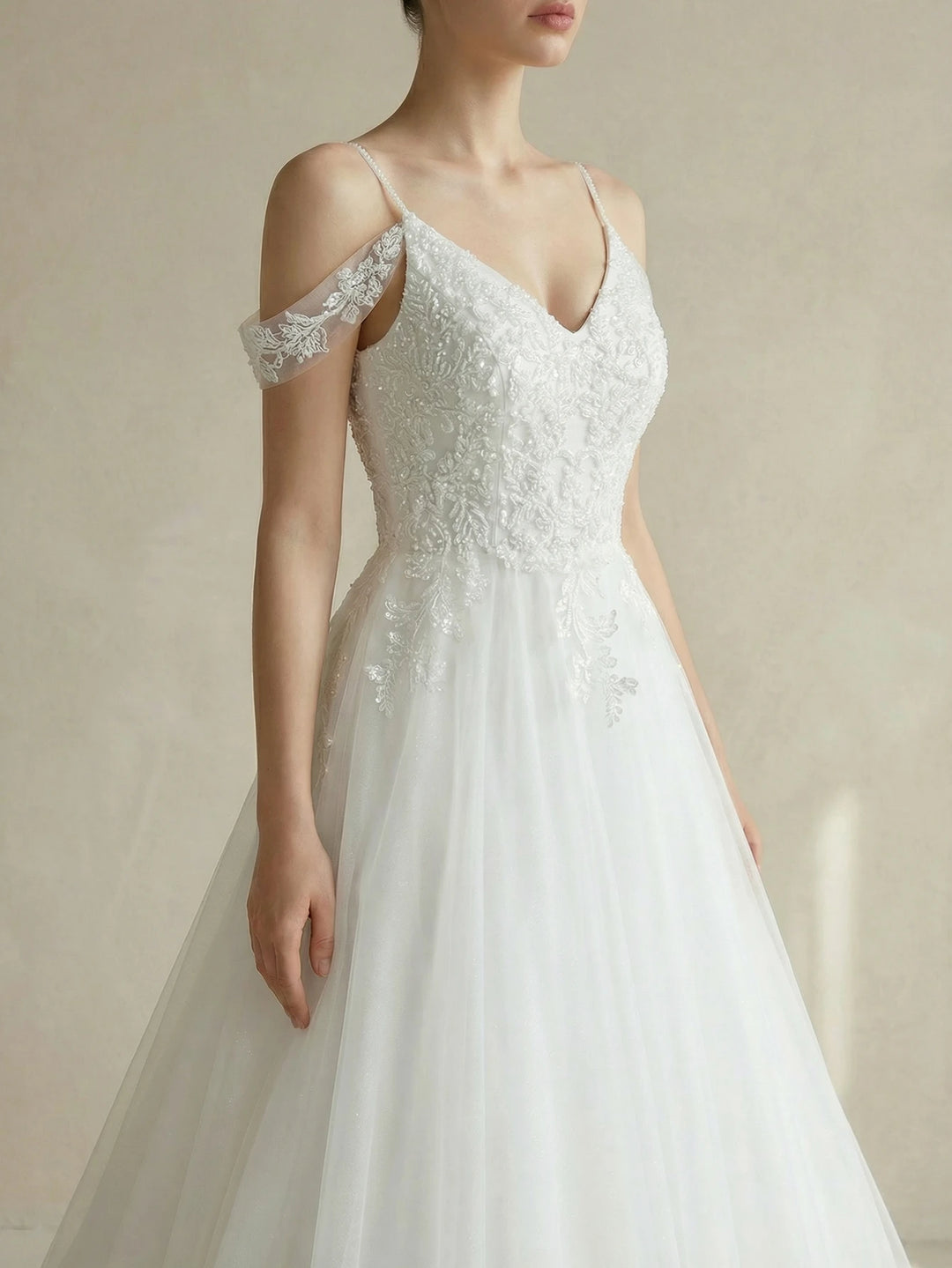 White off-shoulder beaded bridal gown with fitted bodice and layered tulle skirt