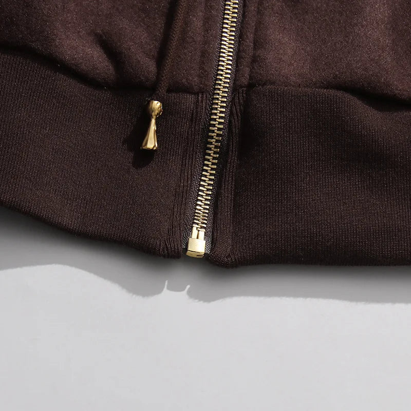 Coffee brown pants close-up of zipper fly with gold-toned pull tab