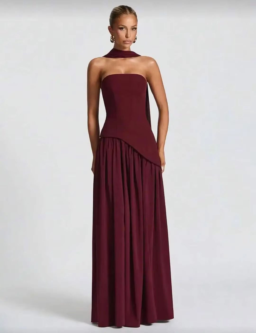 Burgundy high-slit long strapless dress with gathered skirt detail and flowing hem
