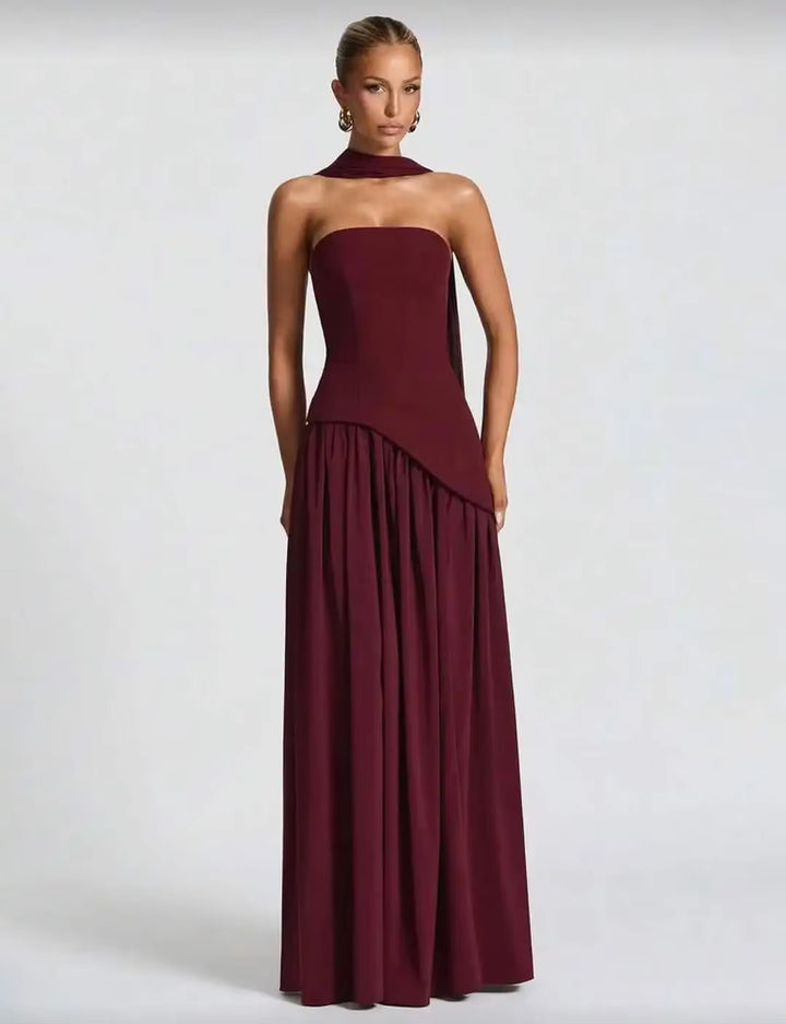 Burgundy high-slit long strapless dress with gathered skirt detail and flowing hem