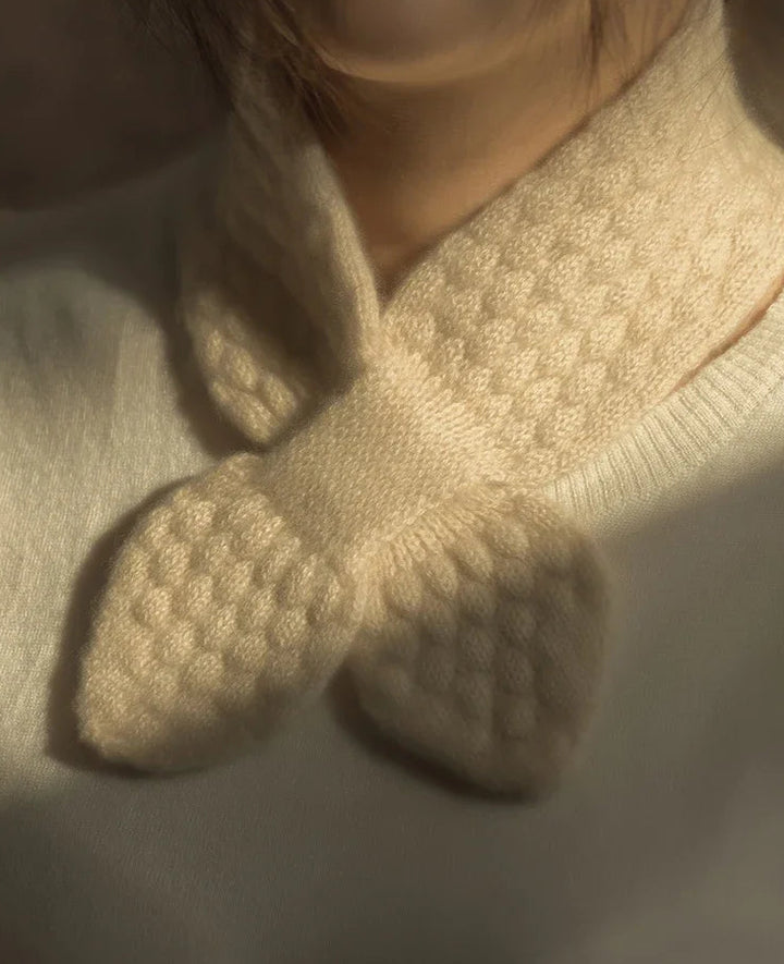 Close-up of beige knitted socks with textured sole on a neutral background