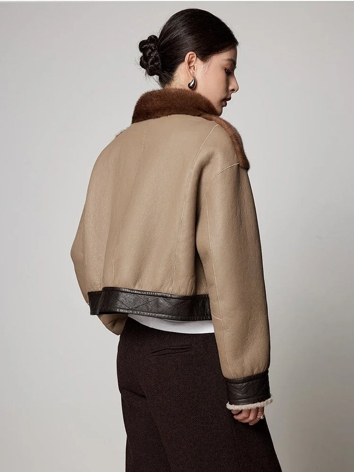 Women’s short mink fur jacket, back view, brown and tan panels with stand collar