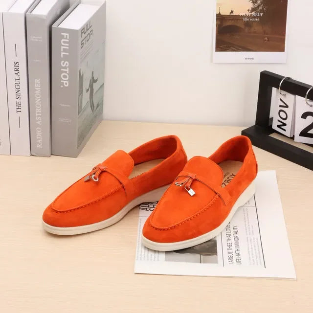 Orange suede slip-on loafers with metal bit detail and white rubber sole