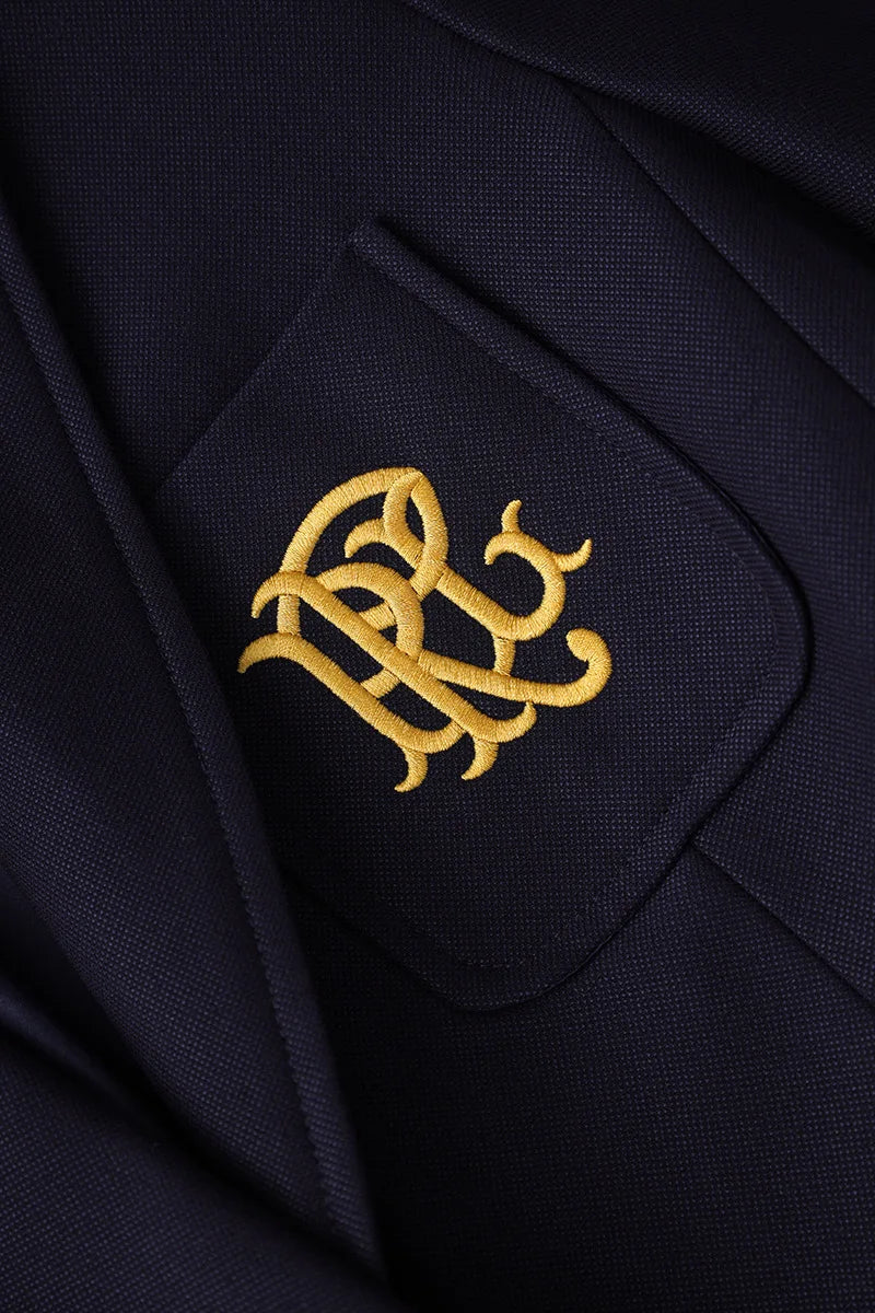 Navy blazer chest pocket with gold embroidered crest design