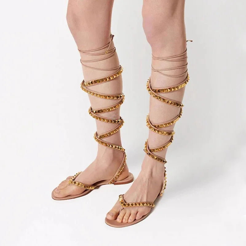 Apricot beige cross-strap flat sandals with gold stud trim and open toe