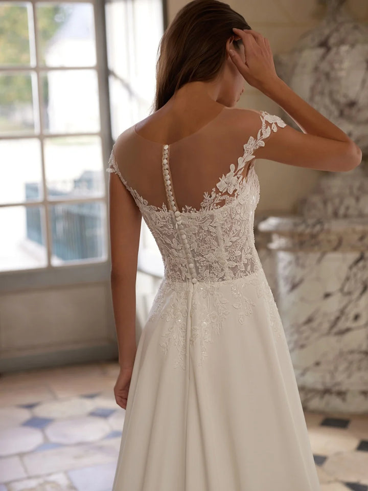 Ivory wedding dress back view with lace embroidery and V-back beaded detail