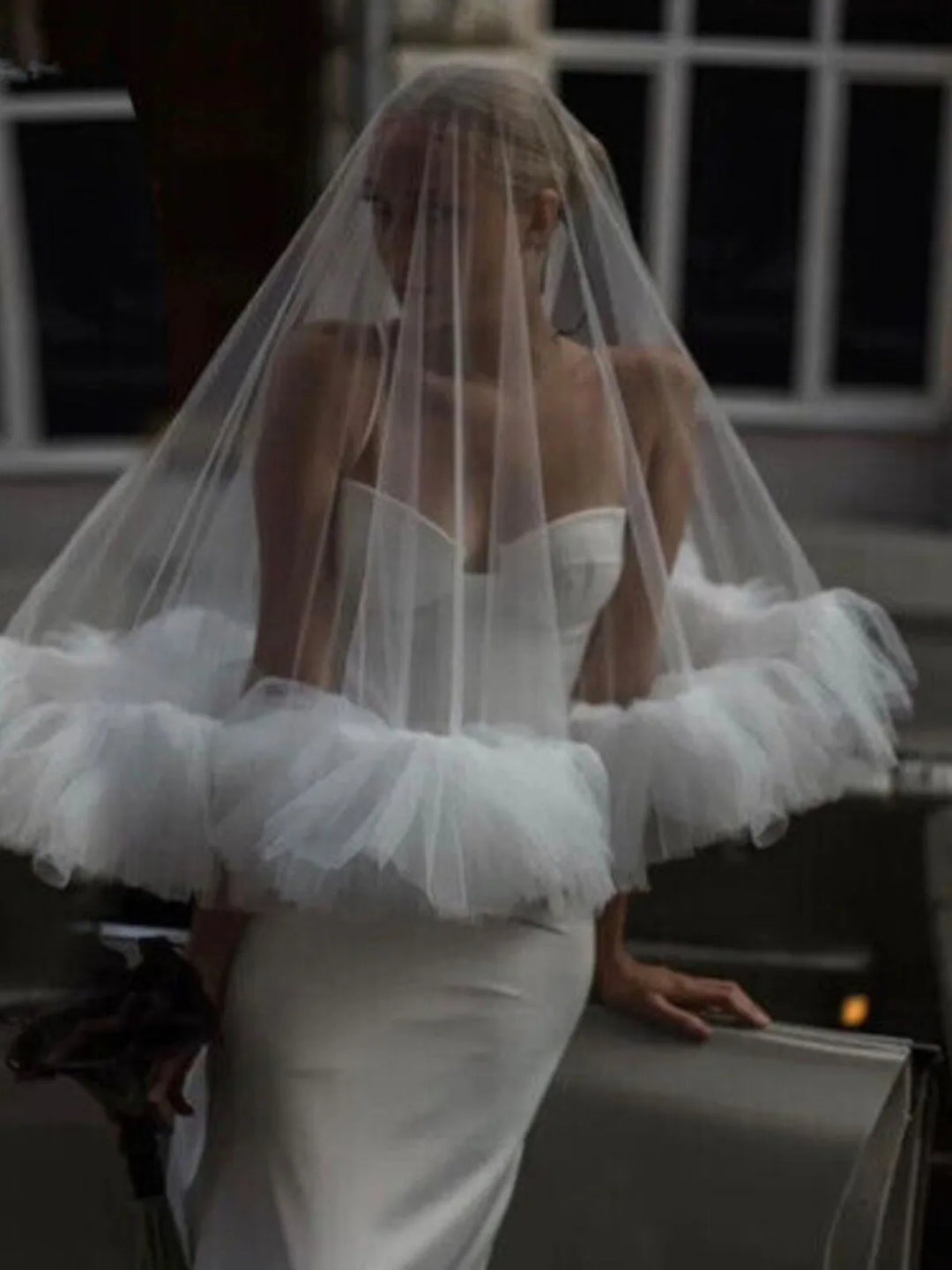 White tulle bridal veil with ruffled hem and sheer tiers