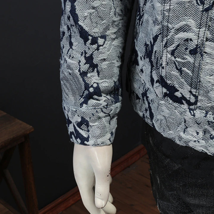 Abstract print jacket sleeve and hem on mannequin, visible button cuff