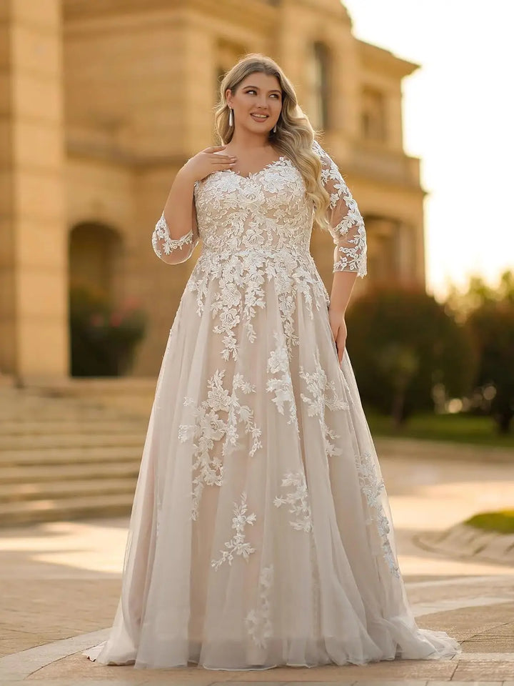 Plus size lace wedding dress with V-neck, long sleeves, and flowing A-line skirt