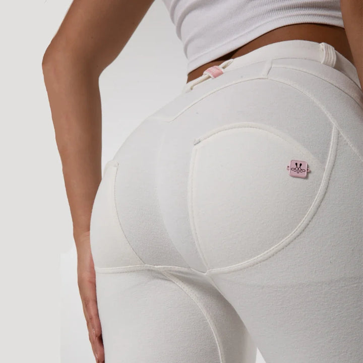 White trousers with large back yoke and small pink brand logo patch