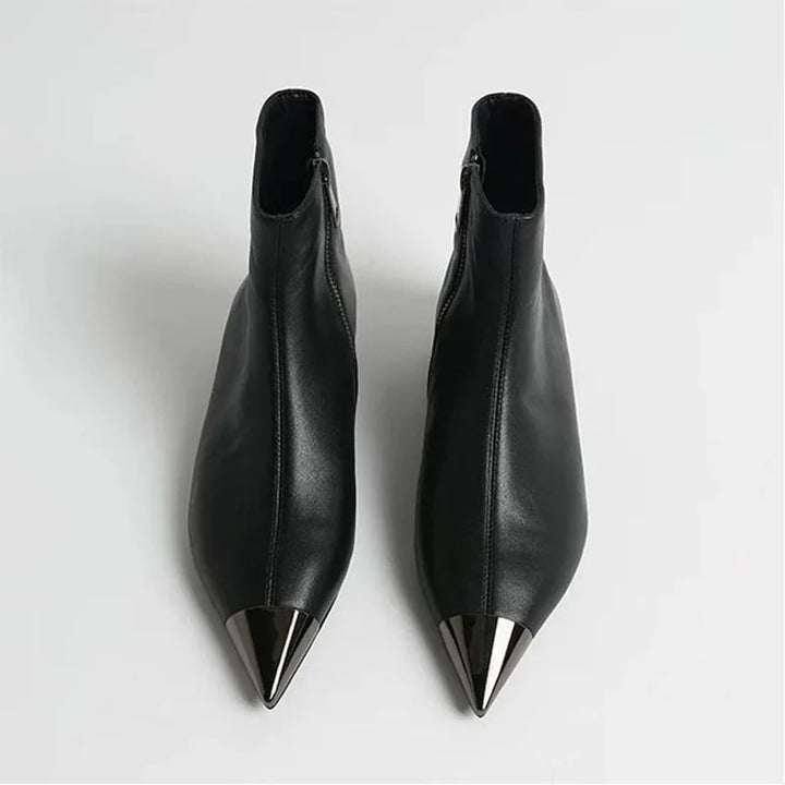 Black pointed-toe ankle heel boots, sleek side profile with tall shaft.