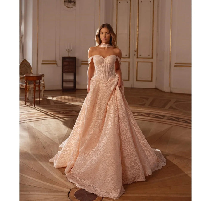 Champagne lace off-shoulder wedding gown with sweetheart neckline and full skirt